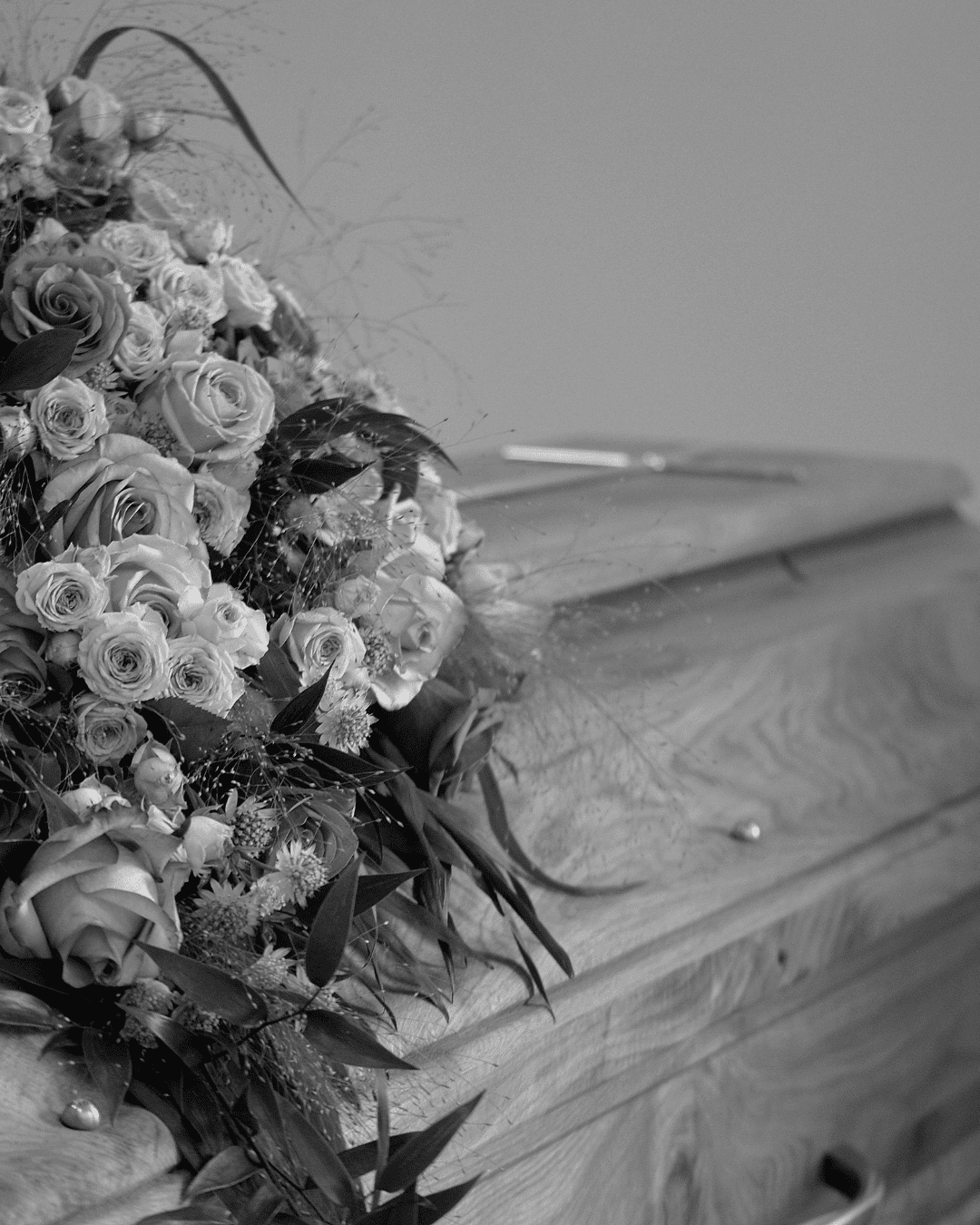 Flowers resting beside a coffin