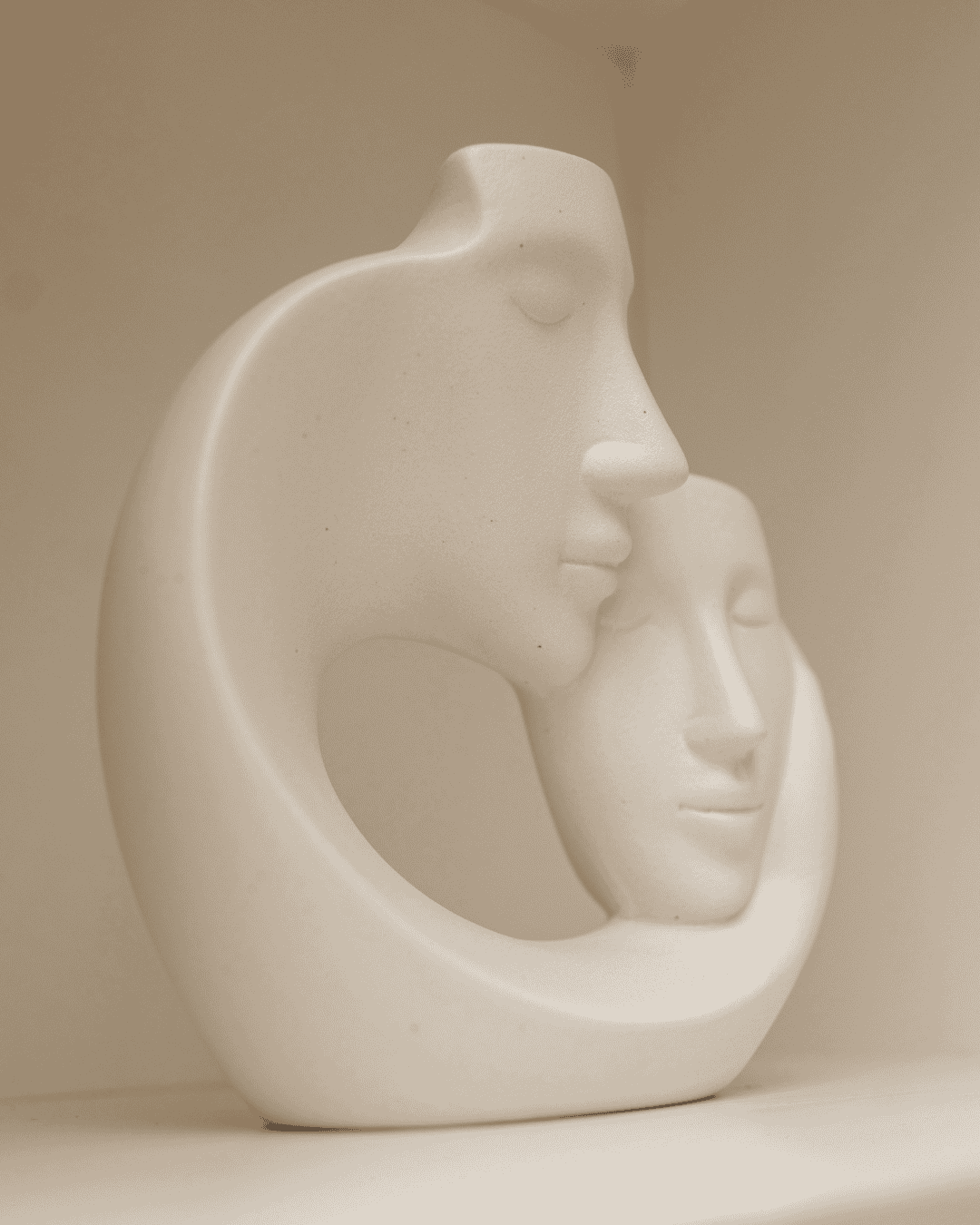Statue of two faces in a close embrace