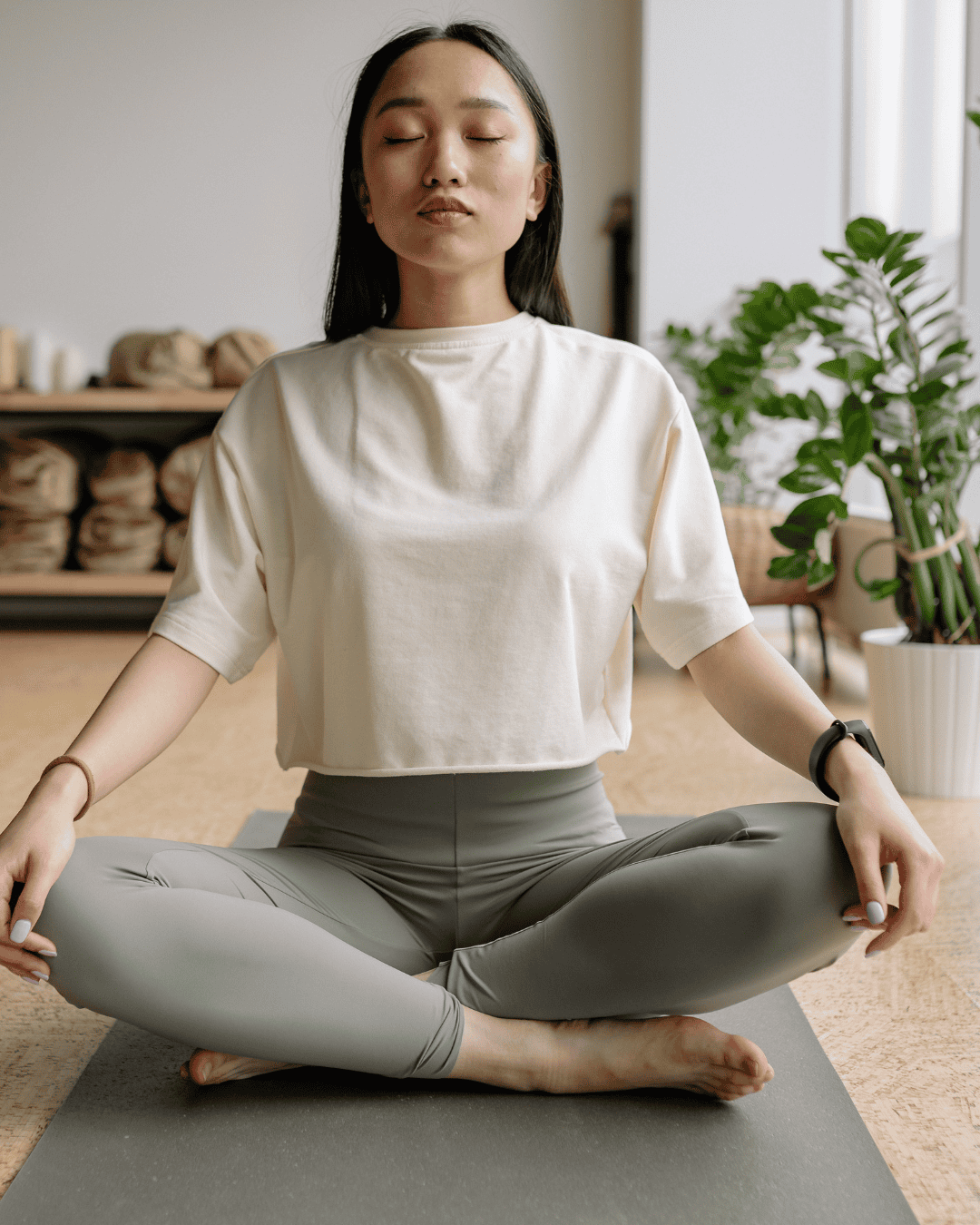 Woman sitting comfortably in meditation at home